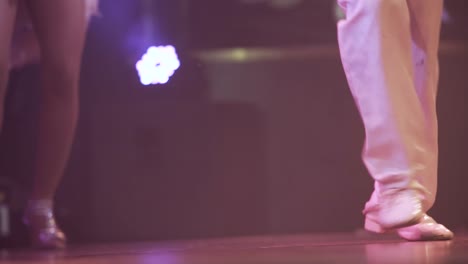 close up of couple of dancer's dancing at a show with white costumes and shiny shoes , lifestyle cuban salsa dance