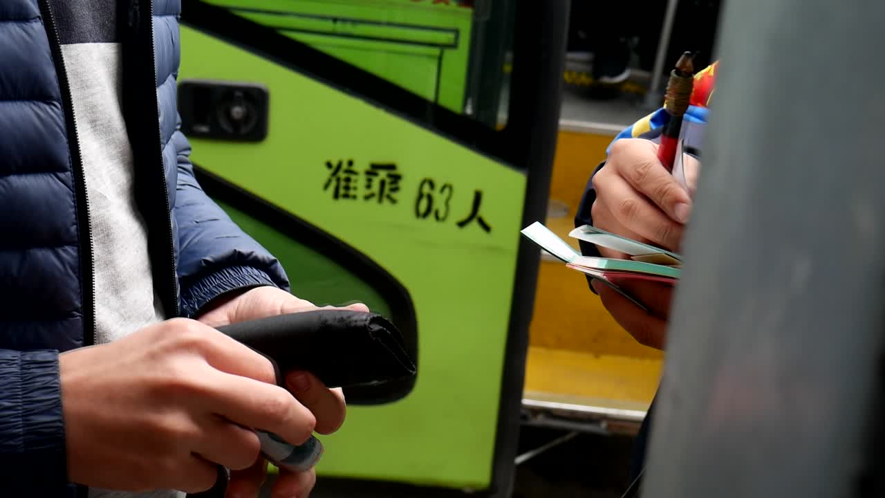 Close Up Of Cash Transaction For Tickets Outside Green Bus In Beijing, China