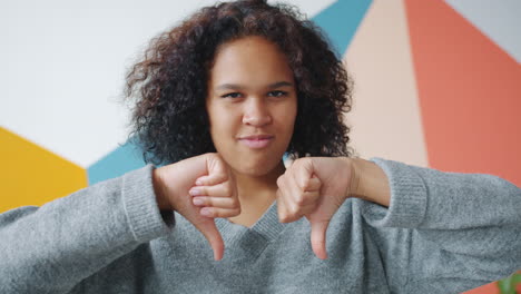 unhappy woman giving a thumbs down