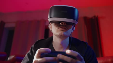 man wearing vr headset playing video game at home