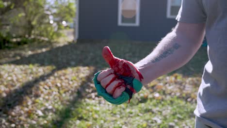 Tracking-out-injured-hand-with-improvised-tourniquet,-Man-move-his-bloody-fingers