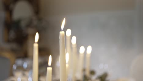 Row-of-lit-white-candles-creating-a-warm-and-serene-ambiance