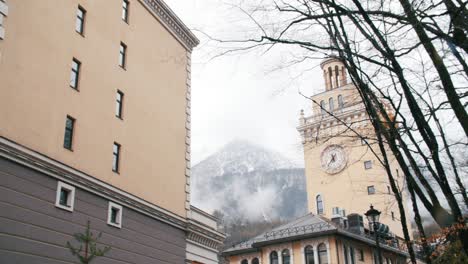 cityscape with a clock tower and mountain view