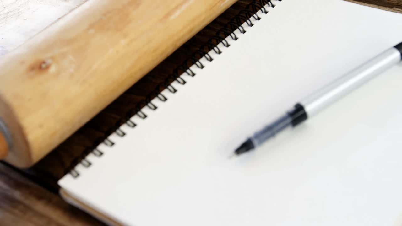 Pen on diary and rolling pin