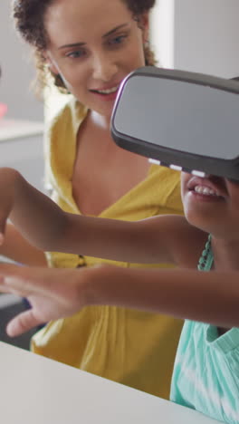 video of happy caucasian female teacher with class of diverse pupils wearing vr headsets