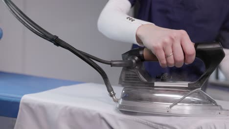 steam ironing in a dry cleaning shop