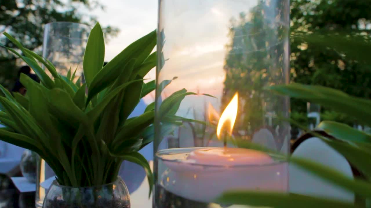 Candlelit table decoration with greenery