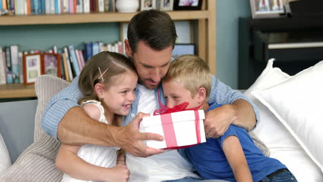 father receiving a gift from his children