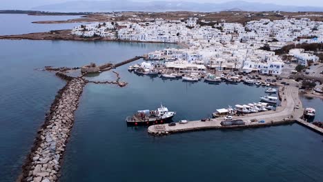 a small boat entering the port of naousa paros greece