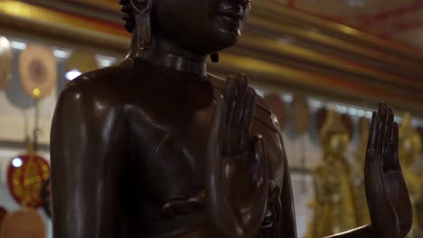 buddha wood statue stand up at buddhist temple rehabilitation bangkok thailand