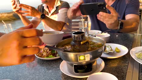 friends enjoying sour soup together in thailand