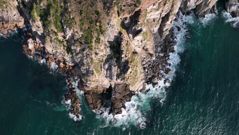 Flight-along-twisted-narrow-road-through-Chapmans-peak-scenic-route---top-down