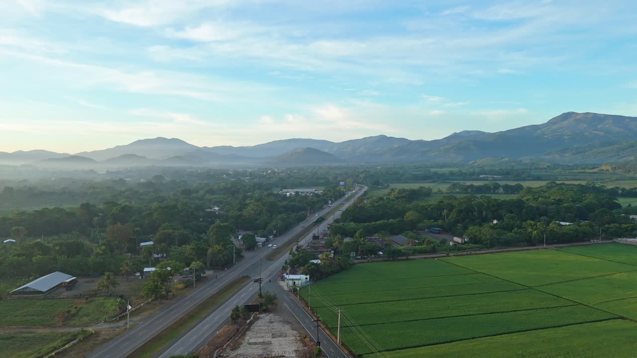 Duarte highway, countryside, green rice fields, Bonao in Dominican Republic, sky for copy space, Aerial drone pov