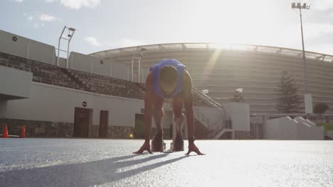 front view of african american athlete running in stadium