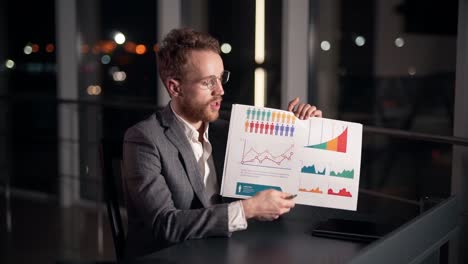 stylish young man gives a presentation on a slide infographic looking at the camera