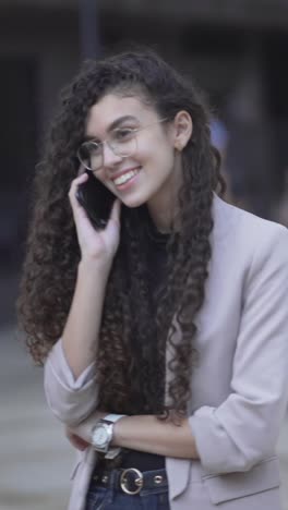 young woman talking on phone and photographer taking photo