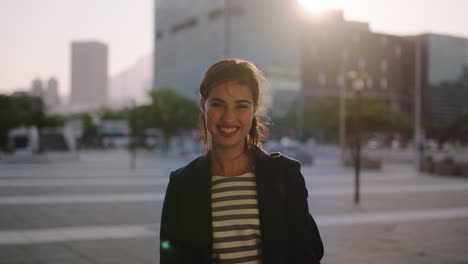 portrait of happy young woman business intern smiling successful at camera in windy city enjoying urban lifestyle achievement