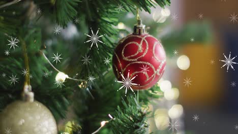 Animation-of-snow-falling-over-christmas-tree-with-baubles