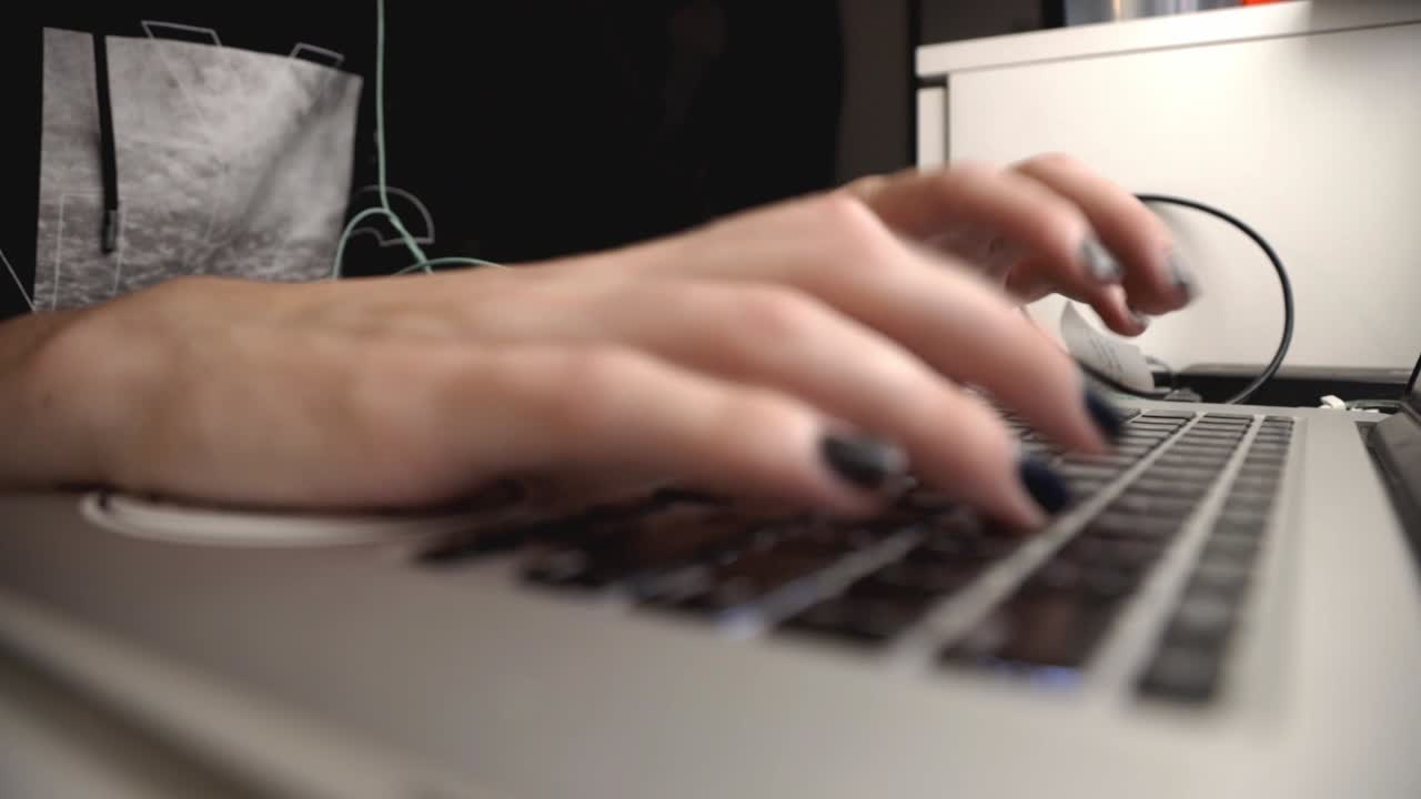 Woman's Hands Typing On A Laptop Keyboard. - close up shot