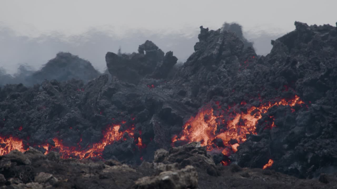 primer plano de lava derretida que fluye lentamente desde el volcán grindavik en el cráter sundhnúkur, islandia