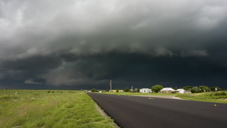 dark storm clouds moving over country road time lapse