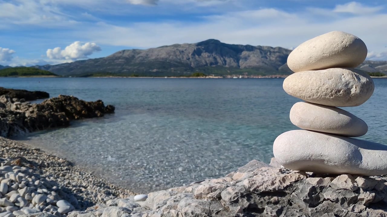 Stack of white stones, calm sea water landscape, inner peace, balance and harmony, zen mindfulness