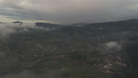 Flying down towards town in Ukraine covered in mist in the morning