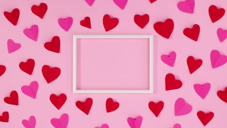 los corazones de san valentín rojos y rosados se mueven alrededor del marco para el texto. detenga el movimiento