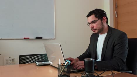young man working on laptop - side view