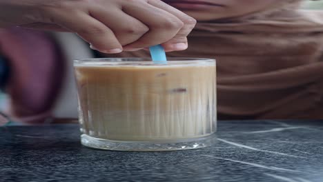 woman drinking iced coffee