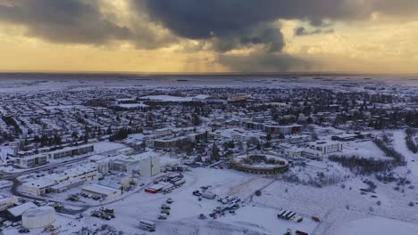 factory and nordic city during winter snow at dramatic sunset