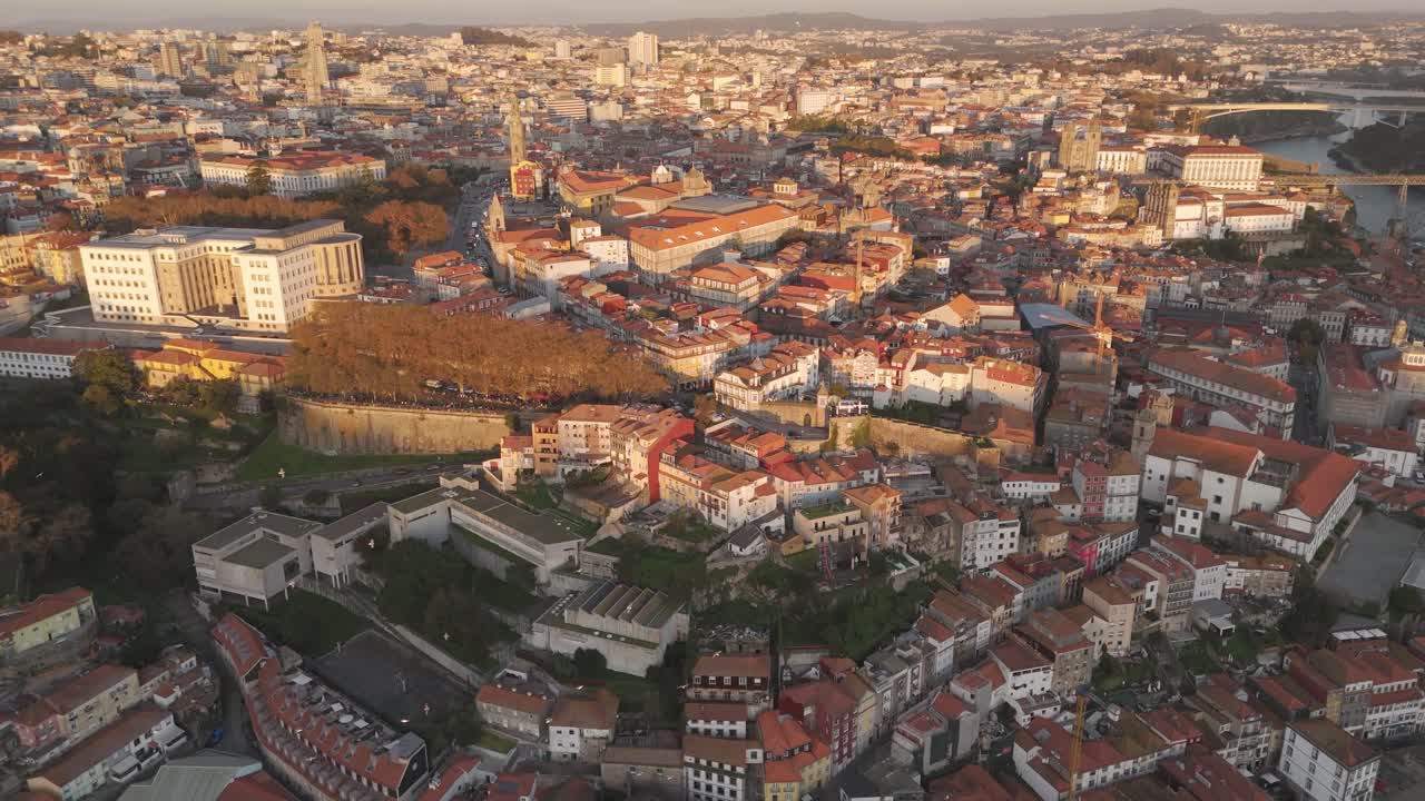Discover the cityscape of Porto, where historic architecture meets the shimmering Douro River. This aerial view captures Porto´s charming old Town, with its terracotta rooftops and winding streets.