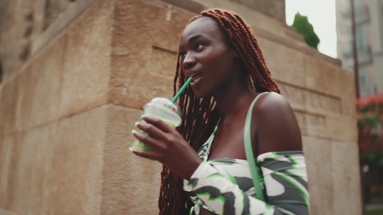 Woman with smoothie in the city