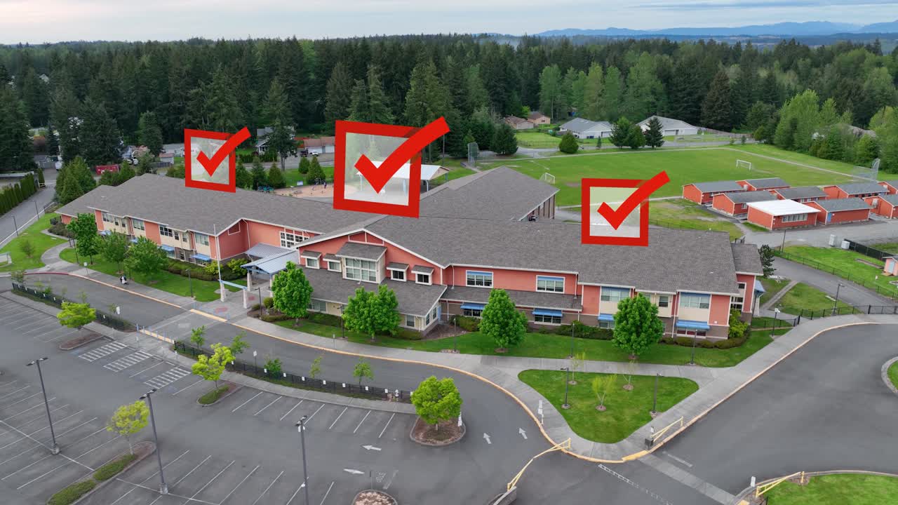 Aerial view of a public school with voting checkmarks appearing overhead