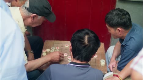 Locals-playing-Chinese-chess-on-the-street-in-Shanghai