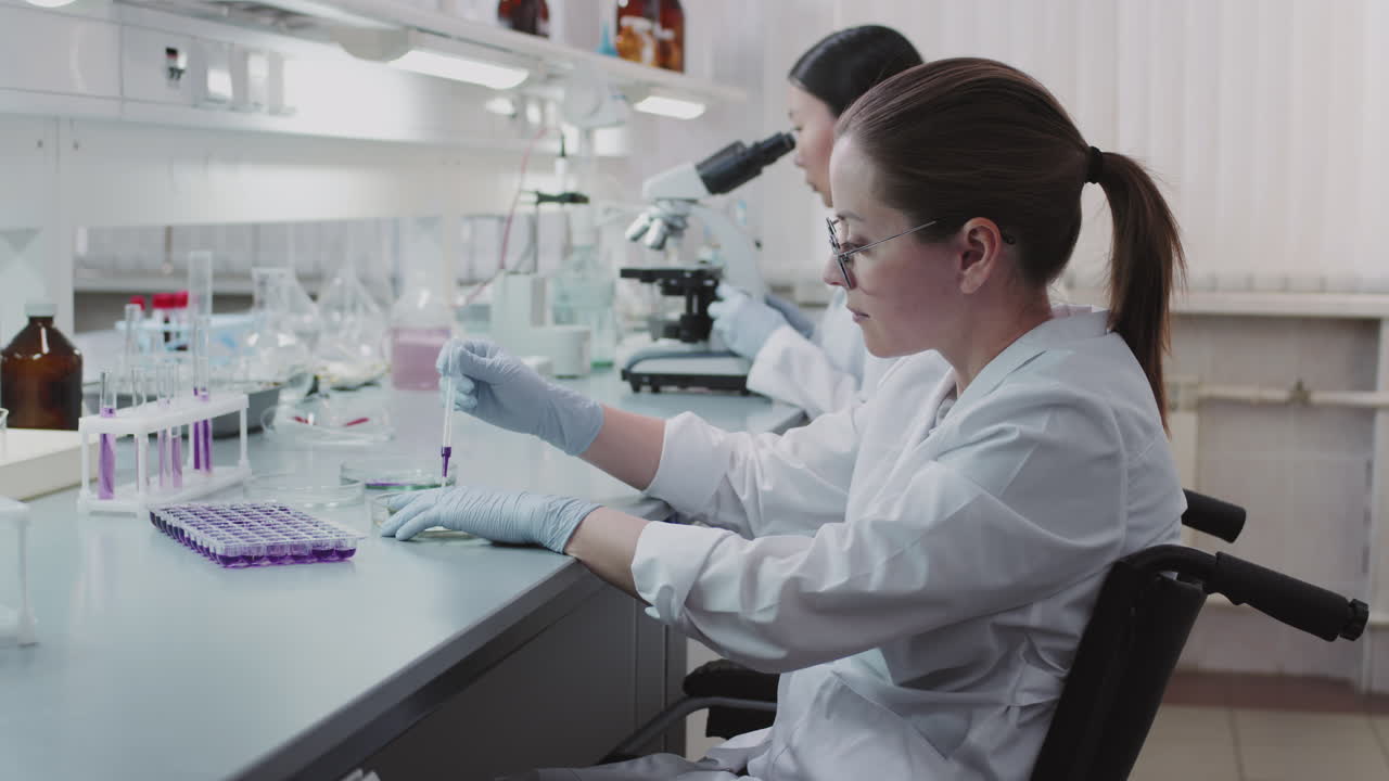 Disabled Female Scientist Working in Lab with Colleagues