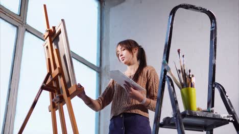 young artist painting in studio