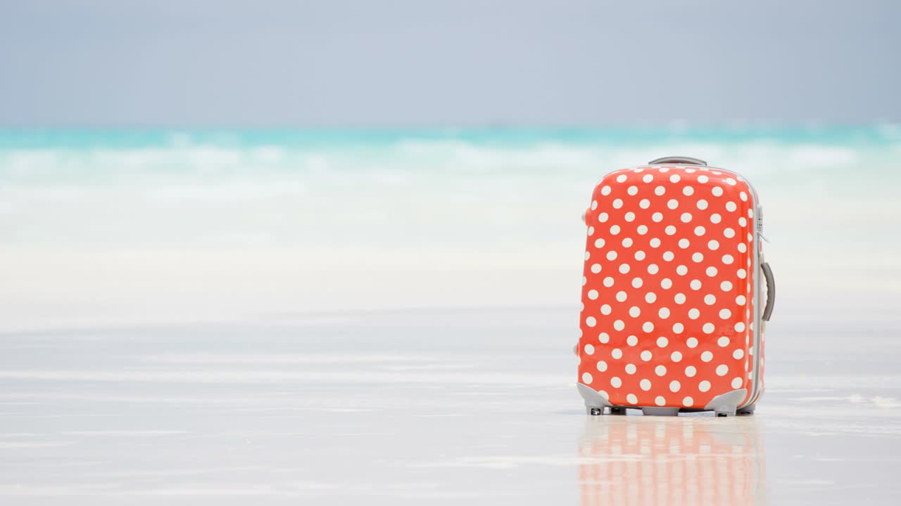 푸르키즈 바다에 의해 열대 해변에서 여행 수하물