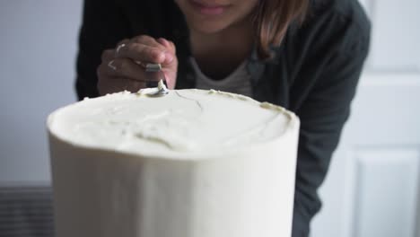 baker trims top of cake slow mo