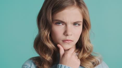 teenage caucasian girl thinking in front of the camera.