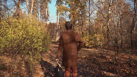 man walking in autumn forest