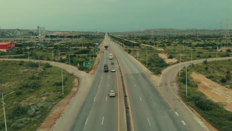 Aerial-Flying-Over-Central-Part-Of-Karachi-Motorway-With-Traffic-Going-Past