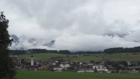 a breathtaking view of dramatic clouds drifting over rugged mountain peaks, showcasing nature's power and beauty.