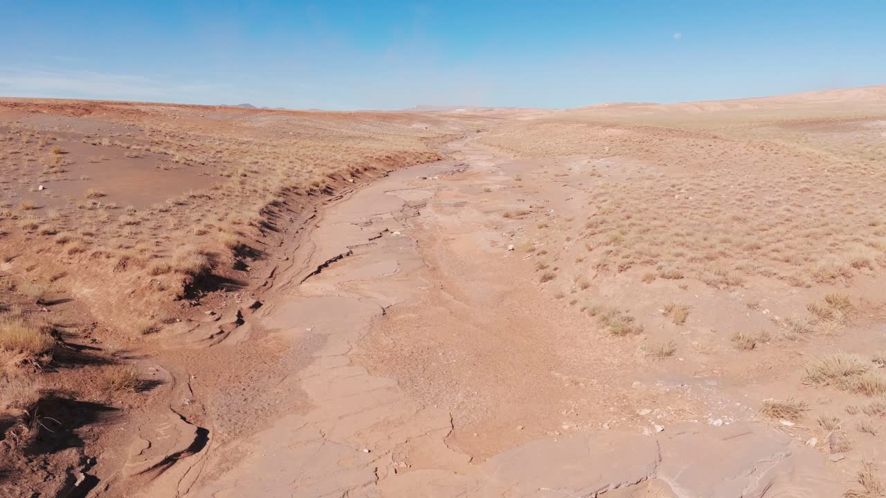 Drone shot over dry riverbed in valley of morocco desert