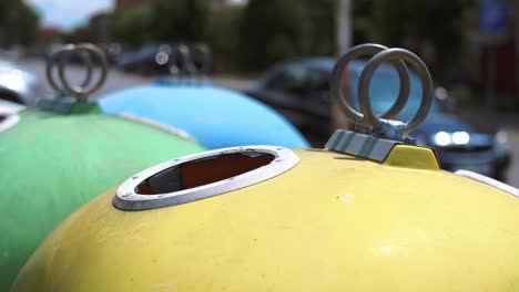 man putting plastic, disposable mug into recycling bin