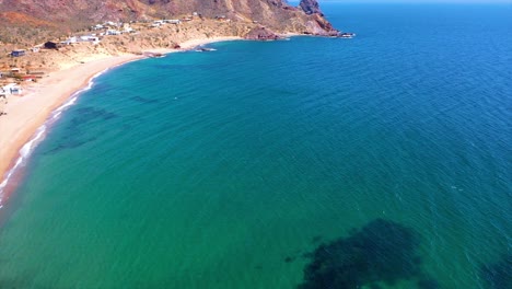 Flight-over-coast-with-green-water