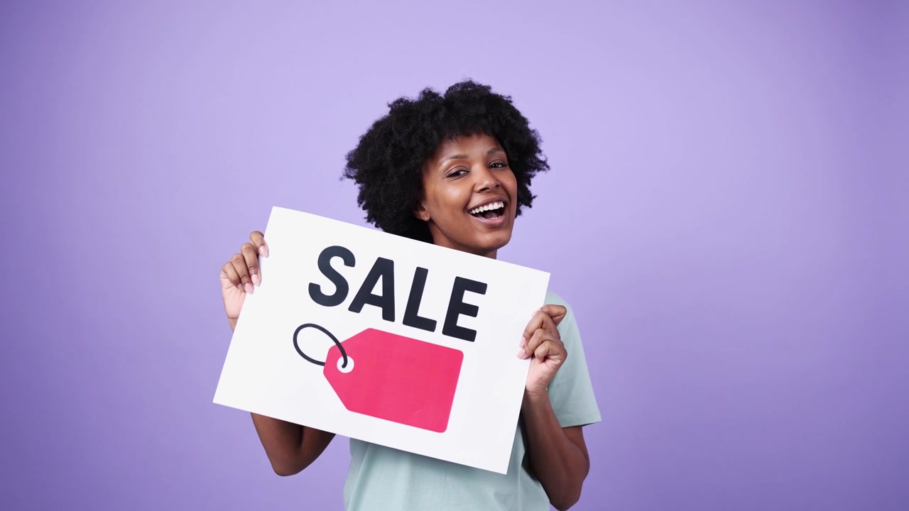 Jeune femme joyeuse tenant une pancarte "Soldes" sur fond violet.