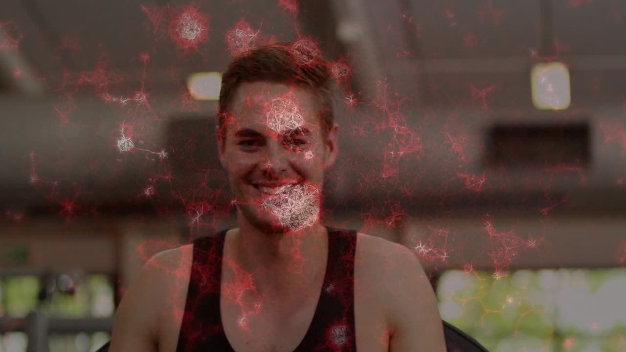 Man gripping handles pressing chest for fitness with red overlay floating as camera showing smile