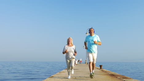 senior couple having morning jog with music