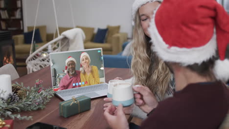 Two-happy-diverse-couples-having-christmas-laptop-video-call,-slow-motion